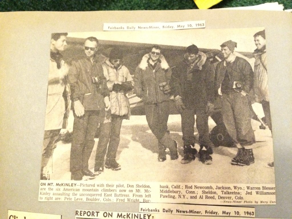 Newspaper photo of 7 men standing in front of a small plane