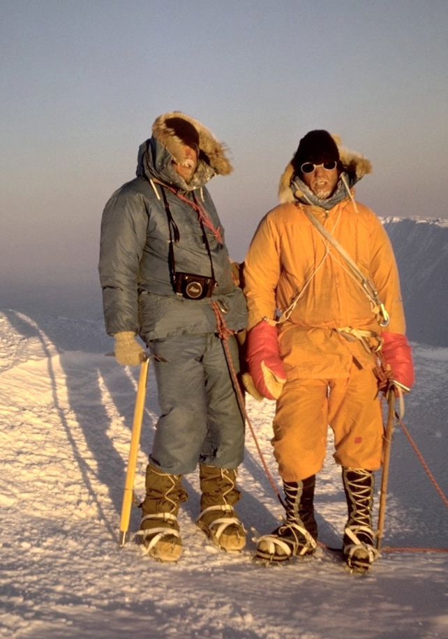 Two climbers in snowsuits and ice on their beards 